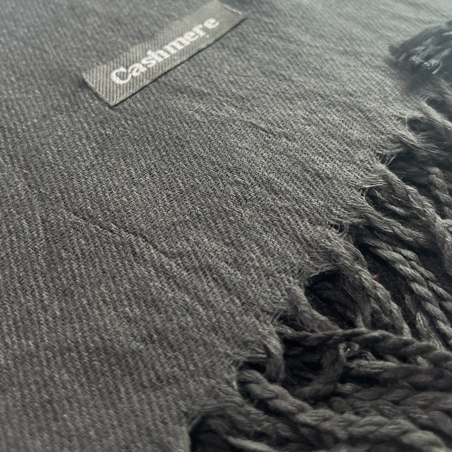 Black scarf with a label on a white background